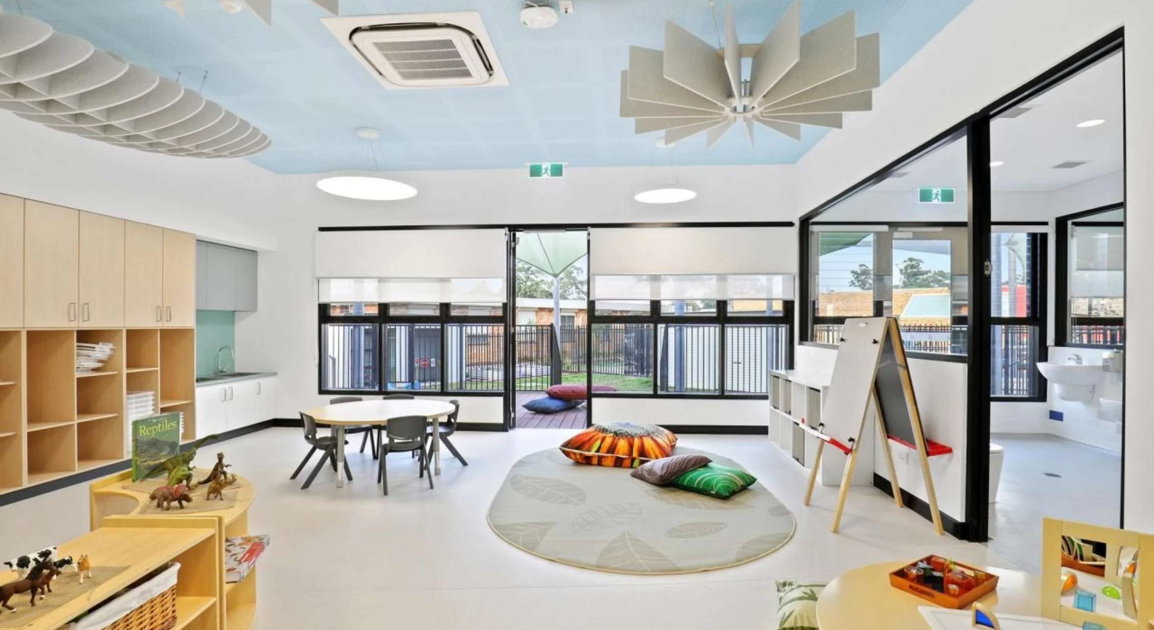 A bright and colorful childcare room featuring light-colored flooring.