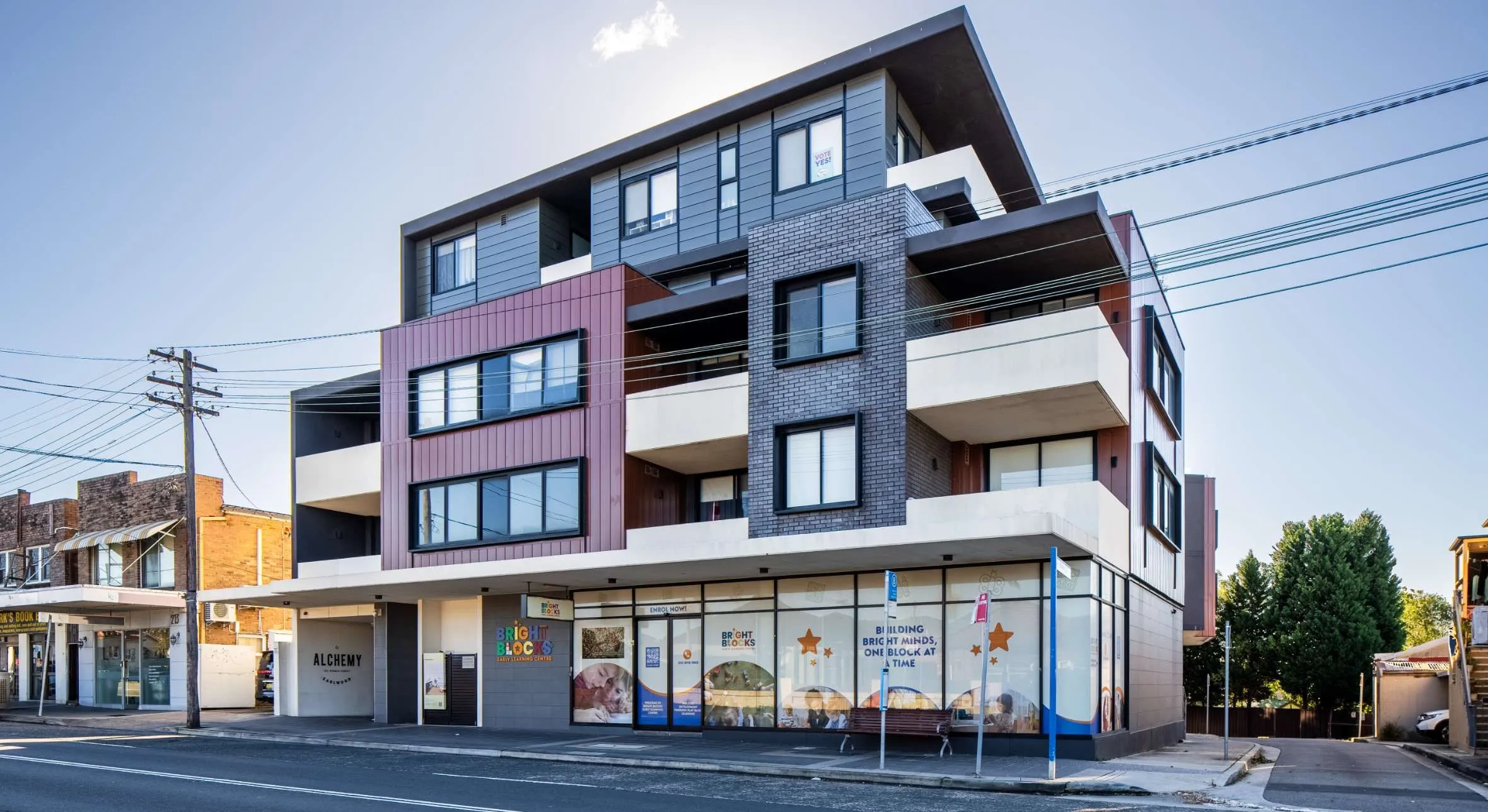 A multi-story commercial and residential building featuring a Bright Blocks Early Learning Centre.