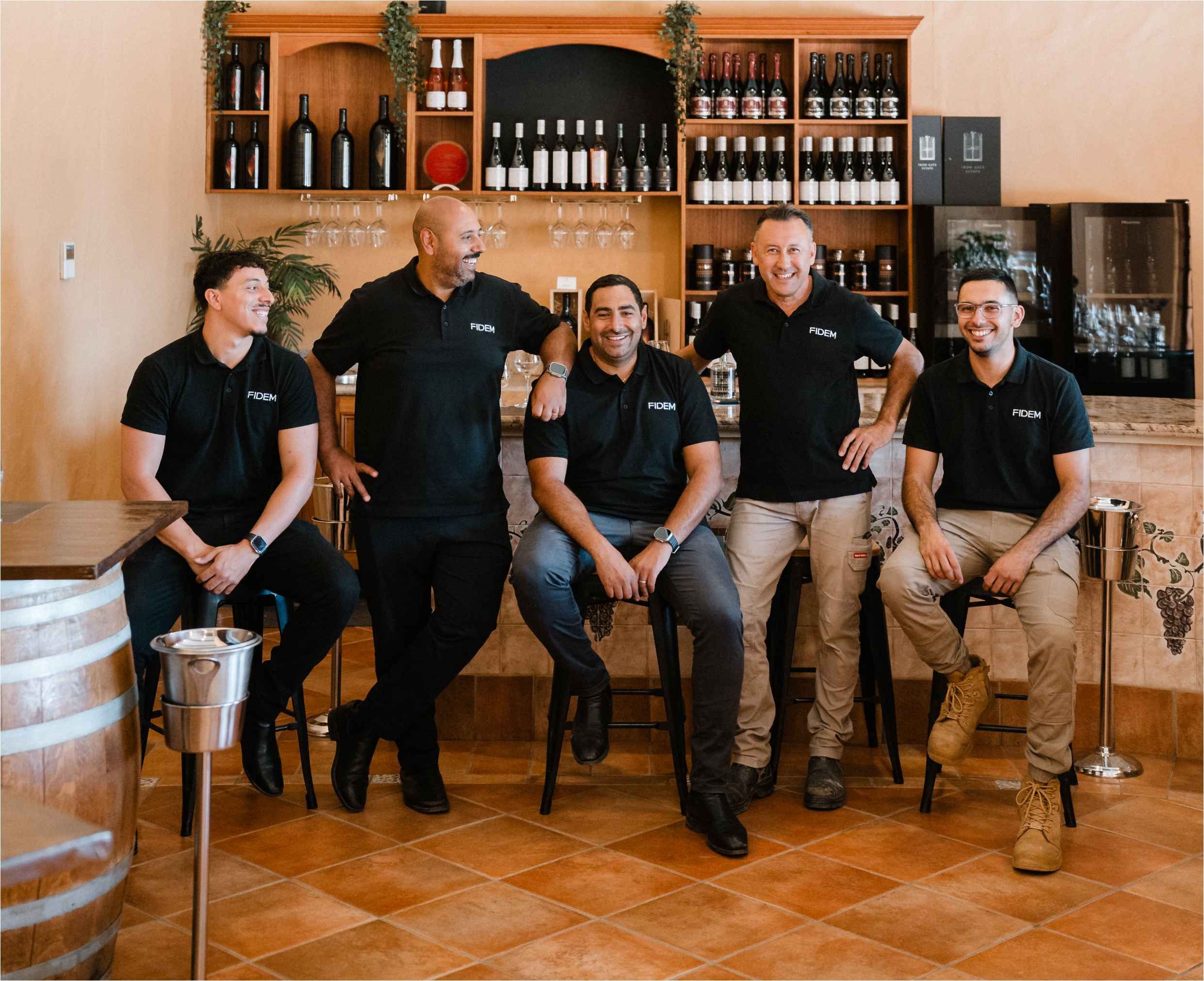 Fidem Team photo in a wine bar setting.